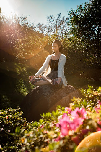 women meditating in natural environment