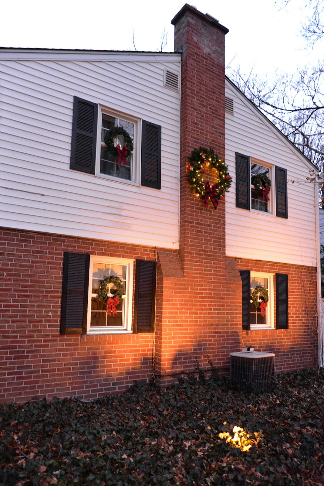 wreath on chimney, wreaths on every window, candles in window wreaths
