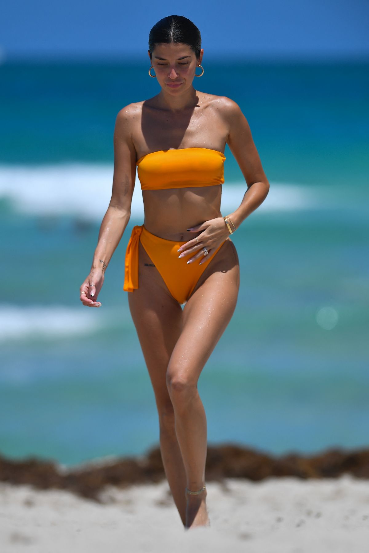 Nicole Williams dazzles in a orange thong bikini at the beach in Miami