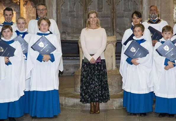 Countess of Wessex visited to join us in celebrating 25 years of Girl Choristers in Wells Cathedral Choir. floral print skirt and pink wool sweater