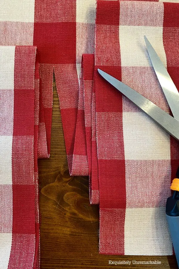 Cutting Red Checked Fabric Down the center of a red line