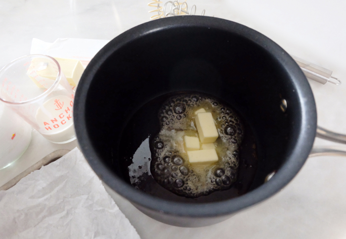 adding butter to melted sugar