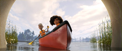 Still from PIXAR's animated film Loop. A Black teen boy and girl are seated in a red canoe together. The boy is holding a paddle.