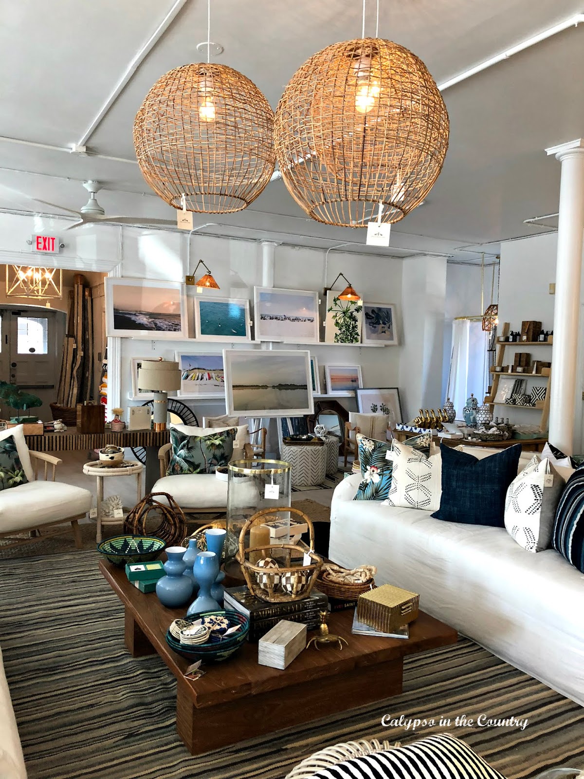 White slipcovered sofa, striped rug, woven pendant lighting, coastal artwork - Coastal Grandmother style decor