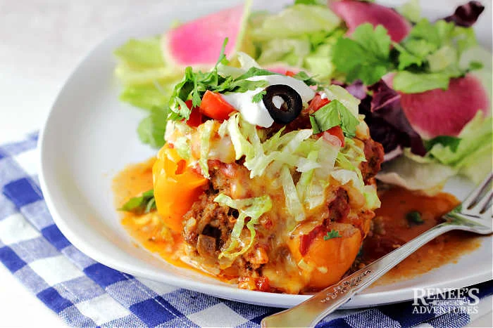 Taco Stuffed Pepper on a plate with salad ready to eat
