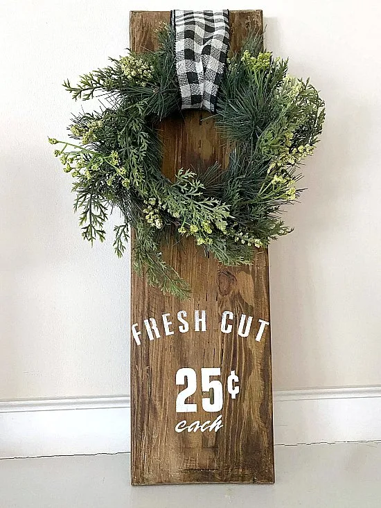 Wreath hanging on wood with stencil