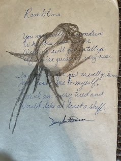 Drawing of a rose with a poem written in cursive blue ink overtop