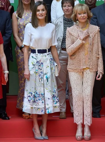 Queen Letizia wore Adolfo Dominguez floral print skirt and she wore Magrit pumps, Hugo Boss satin blouse, carried Magrit clutch bag