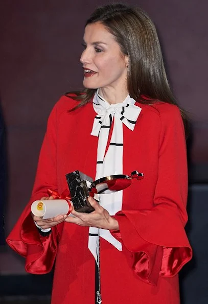 Queen Letizia wore a Zara Frilled Sleeve Coat and Roberto Verino Blouse, Carolina Herrera black-patent and suede pumps and carried Carolina Herrera Animal Print Clutch Bag