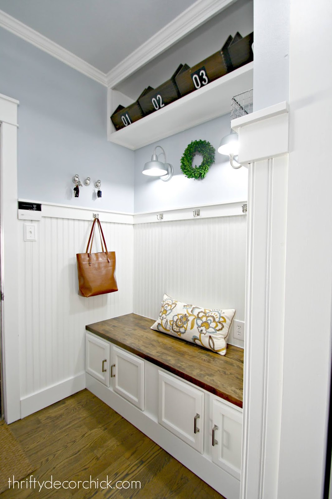 Pretty DIY mud room bench with cabinets