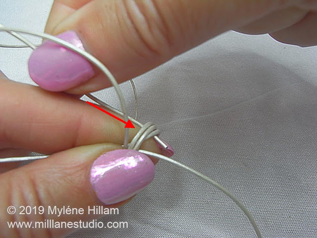 Inserting the tail of the working cord through the coils of the sliding knot.