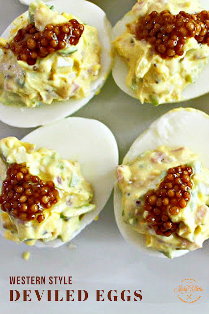 Western style deviled eggs - diced ham, onion and green pepper mixed with yolks and topped with sweet pickled mustard seeds. Deviled eggs make the perfect one-bite party appetizer!