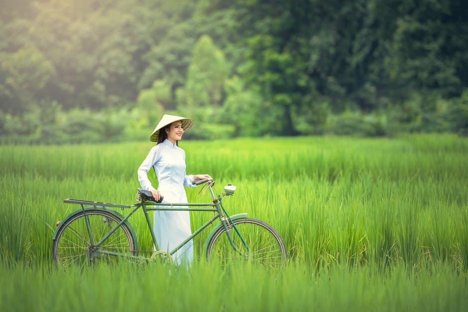 Woman With Bicycle on Grass