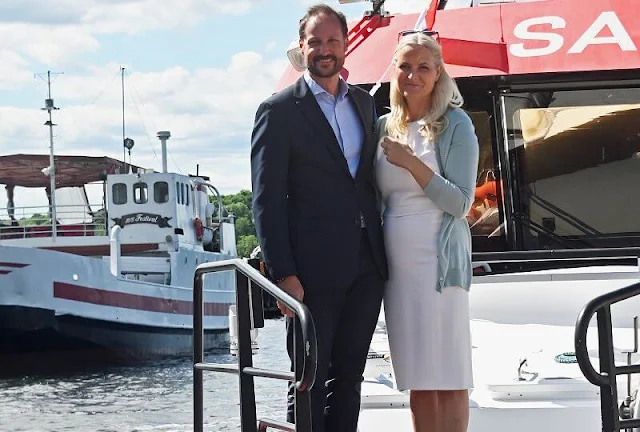 Crown Princess Mette-Marit wore nude eloise flats by Christian Louboutin. Maria La Rosa green clutch. Saint Laurent sunglasses