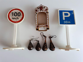 Toy '100 km/h' and 'P 30 m' signs, small enamelled frame and tear drop earrings.