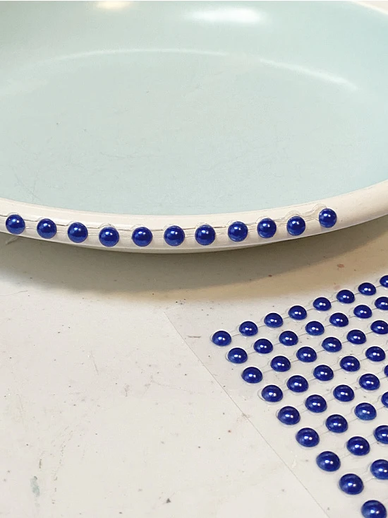 adding beads to dish