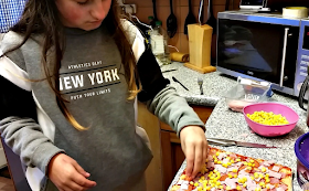 My youngest adding toppings to her pizza