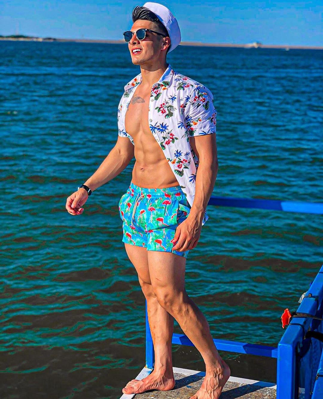 cute-young-fit-male-model-bare-chest-vacation-sea-water-stud