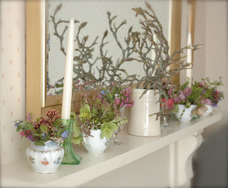 Flowers left over from the stall on my living room mantlepiece.