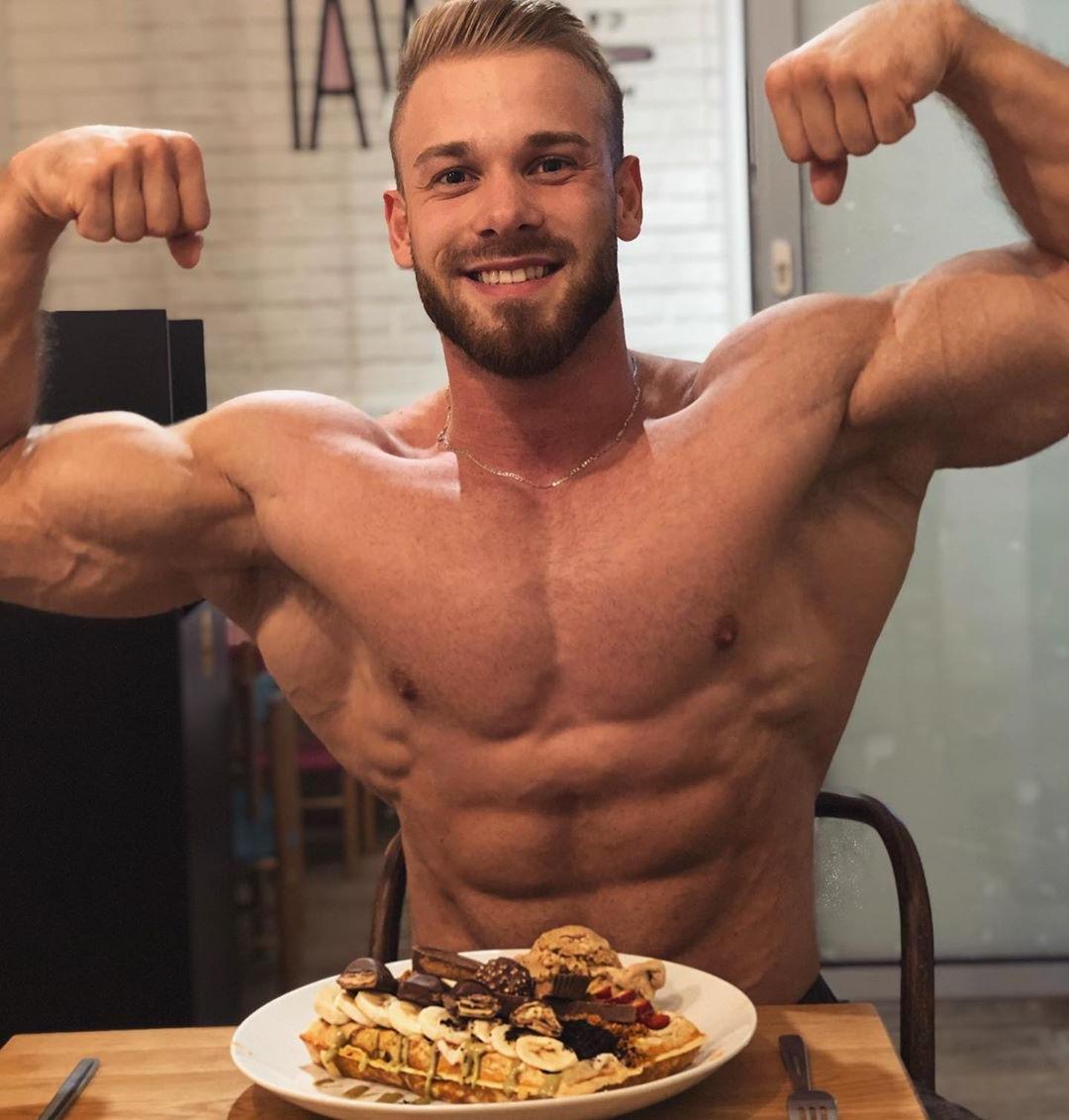 attractive-shirtless-muscle-hunk-biceps-flex-smiling-eating-food