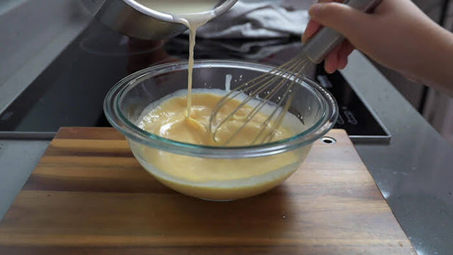 Add hot milk into eggs mixture