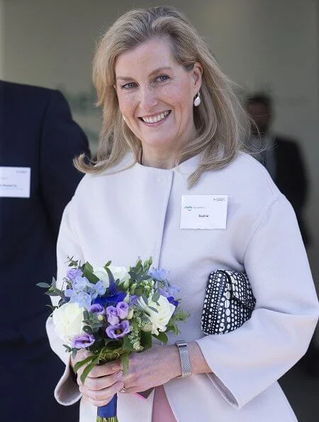 Countess of Wessex wore a bell sleeve wool and silk blend dress by Valentino and Prada cocoon coat, monica vinader earrings. Meghan Markle