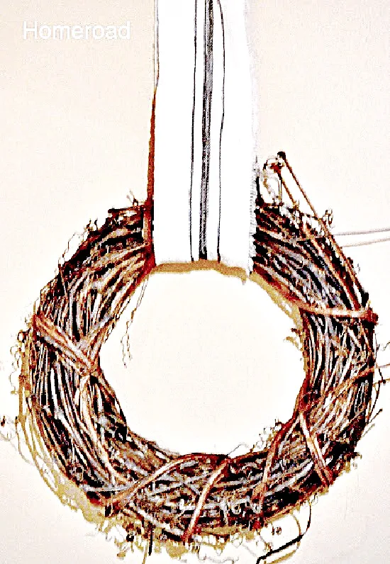 wreath hanging from diy grain sack ribbon