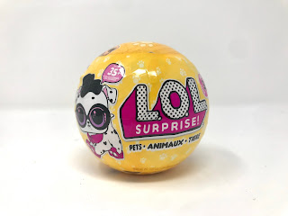 The unopened ball is yellow and says L.O.L Surprise in large writing