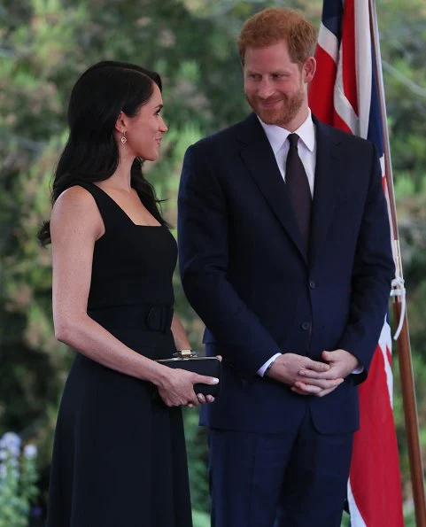 Meghan Markle wore a bespoke black sleeveless dress by Emilia Wickstead, and Deneuve shoes by Aquazzura. She carried a black satin clutch by Givenchy