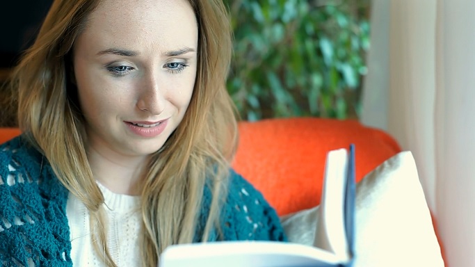 women crying while reading bible