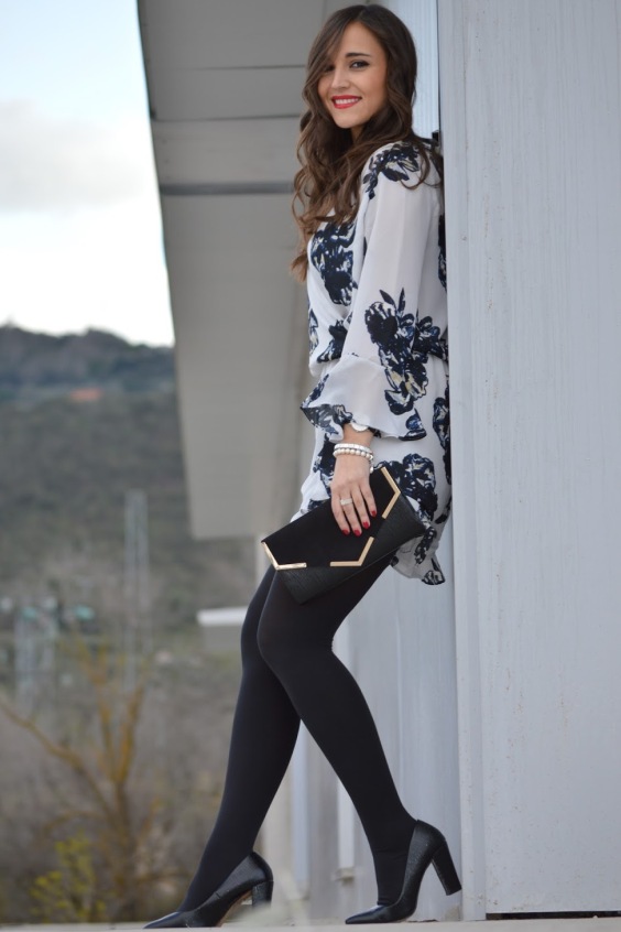 Sexy woman wearing floral dress and black tights