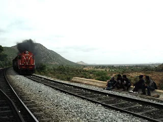 Hikers give way to a passing train at the Makalidurga Railway trek