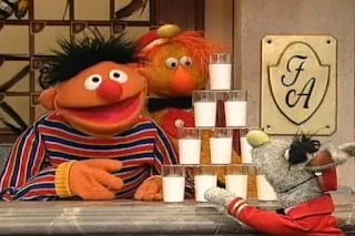 Ernie and the Dinger dings 10 times and Benny brings 10 glasses of milk. Sesame Street 123 Count with Me