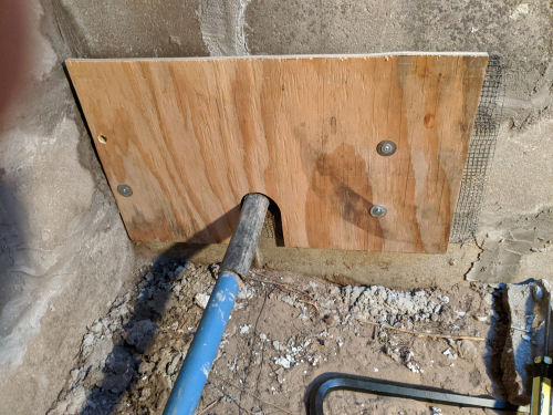 wood partition over an opening in a well pit
