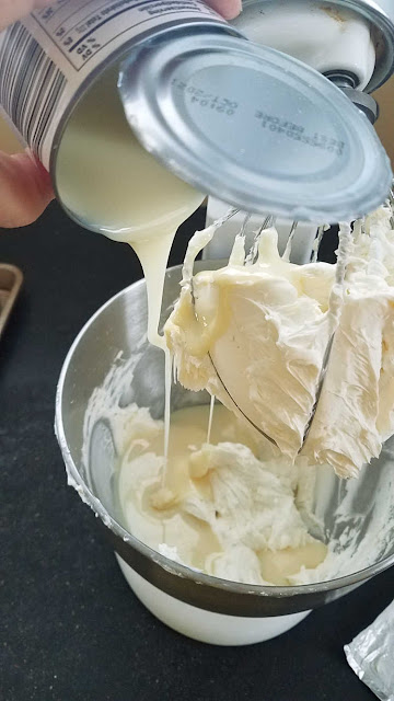 pouring sweetened condensed milk into mixer pouring sweetened condensed milk into beaten cream cheese in mixer bowl
