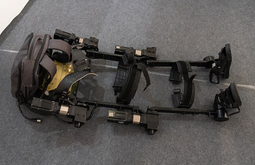 Future scope of robotics and Challenges, Opportunities 1 black robotics legs with chocolate color beg is kept on the floor are called Exoskeletons
