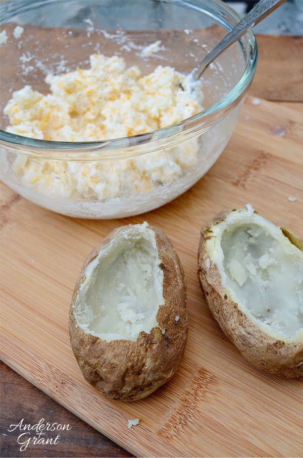 Cut the tops off of potatoes, scoop out the insides, and fill with potato mixture for delicious stuffed potatoes | www.andersonandgrant.com