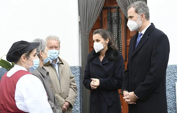 Queen Letizia wore a Canika wool with wrap belt coat from Hugo Boss, and stripe navy trousers and blazer from Boss, and oxford shoes from Uterque