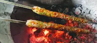 Cooking Seekh Kebab over charcoal Tandoor for chicken Gilafi Seekh Kebab recipe