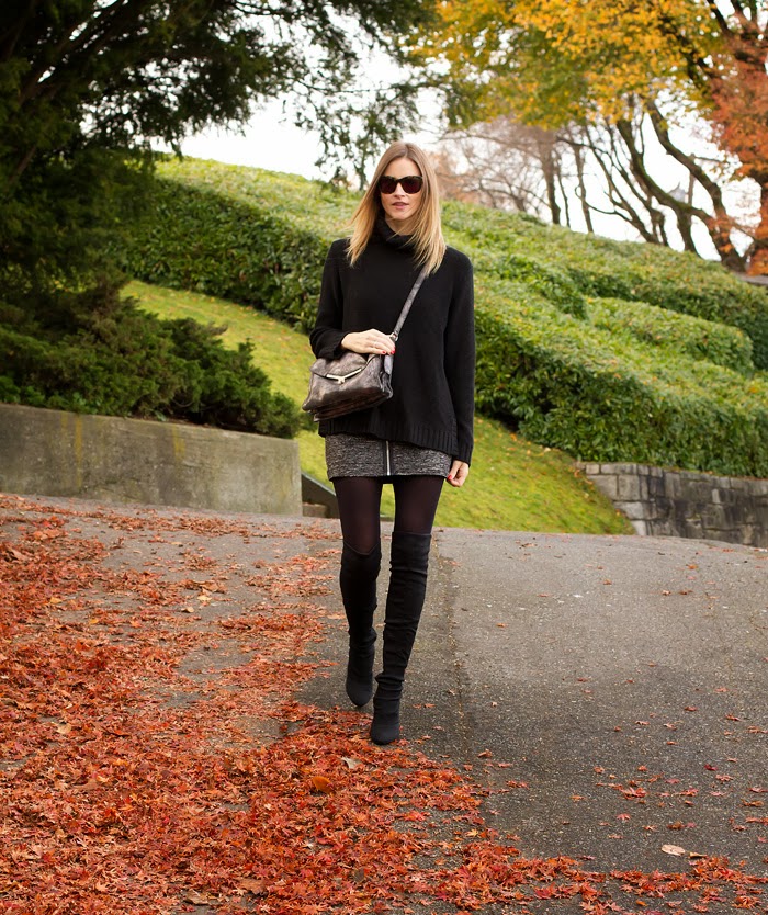 Vancouver Fashion Blogger, Alison Hutchinson, is wearing a black H&M turtleneck sweater, grey Aritzia Skirt, Black nine west over-the-knee boots, a silver botkier valentina bag and Sass & Bide sunglasses