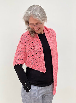 Hand knitted shawl draped over shoulders