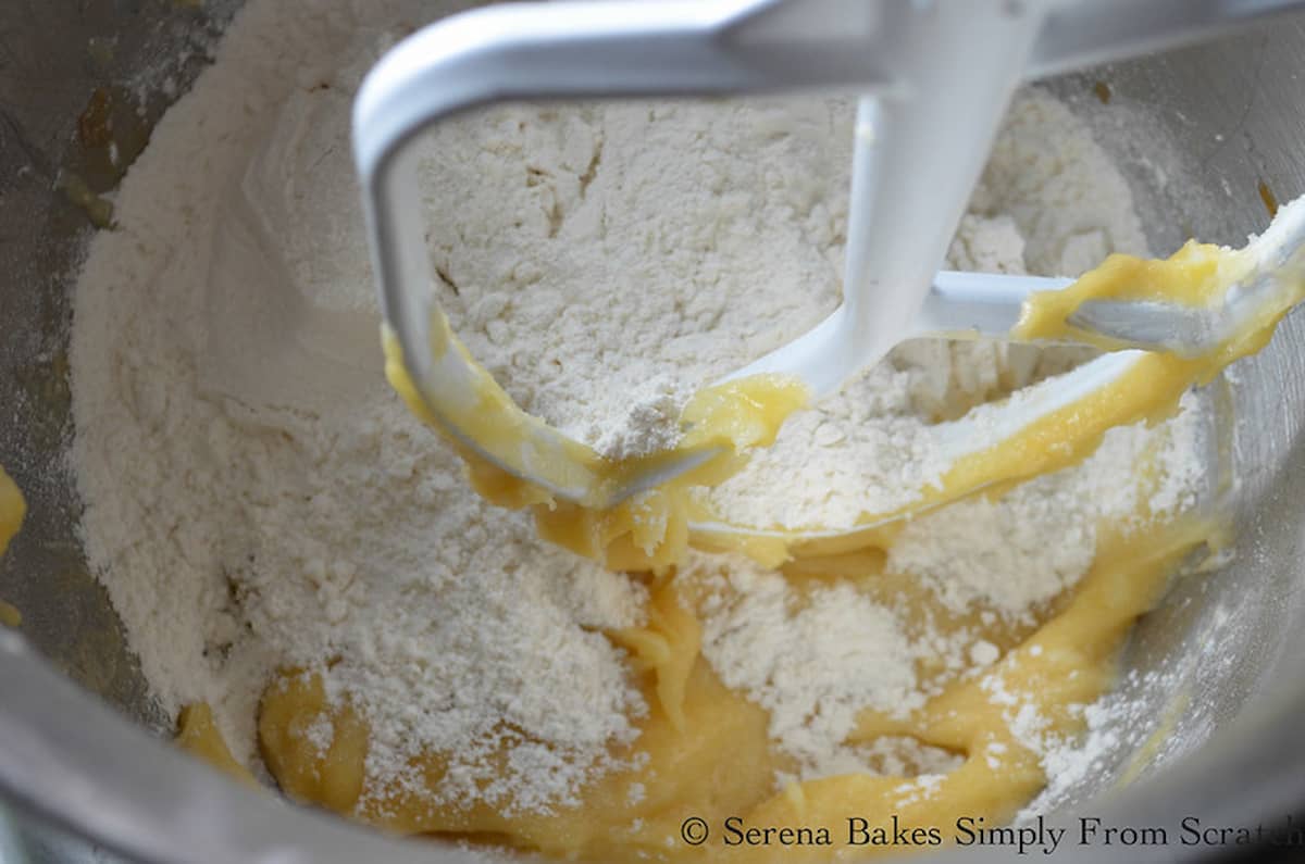 Flour added to Chewy Lemon Cookie Dough in a mixer.