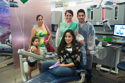 image of a family with dental hygiene students at clinic.