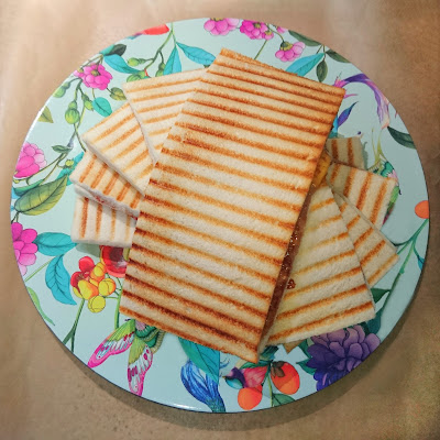 Image of a colored plate with italian tramezzini lying on it.