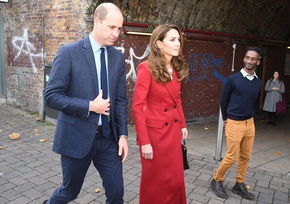 Kate Middleton was chic in a gorgeous autumnal red coat by Alexander McQueen. Grace Han Love bag. Daniella Draper luxury Maxi cupid hoops