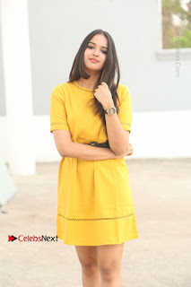 Actress Poojitha Stills in Yellow Short Dress at Darshakudu Movie Teaser Launch  0002