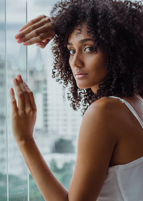 [Image: woman-leaning-on-clear-glass-wall-2146038.jpg]