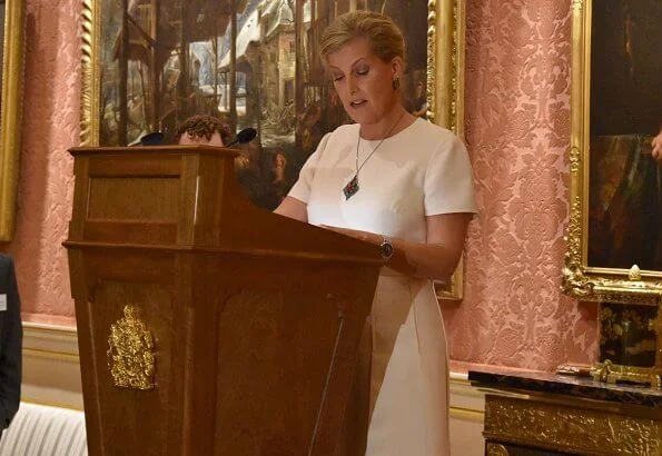 The Queen and Countess of Wessex hosted a reception. Queen wore royal blue dress. Emilia Wickstead skirt, Victoria Beckham top