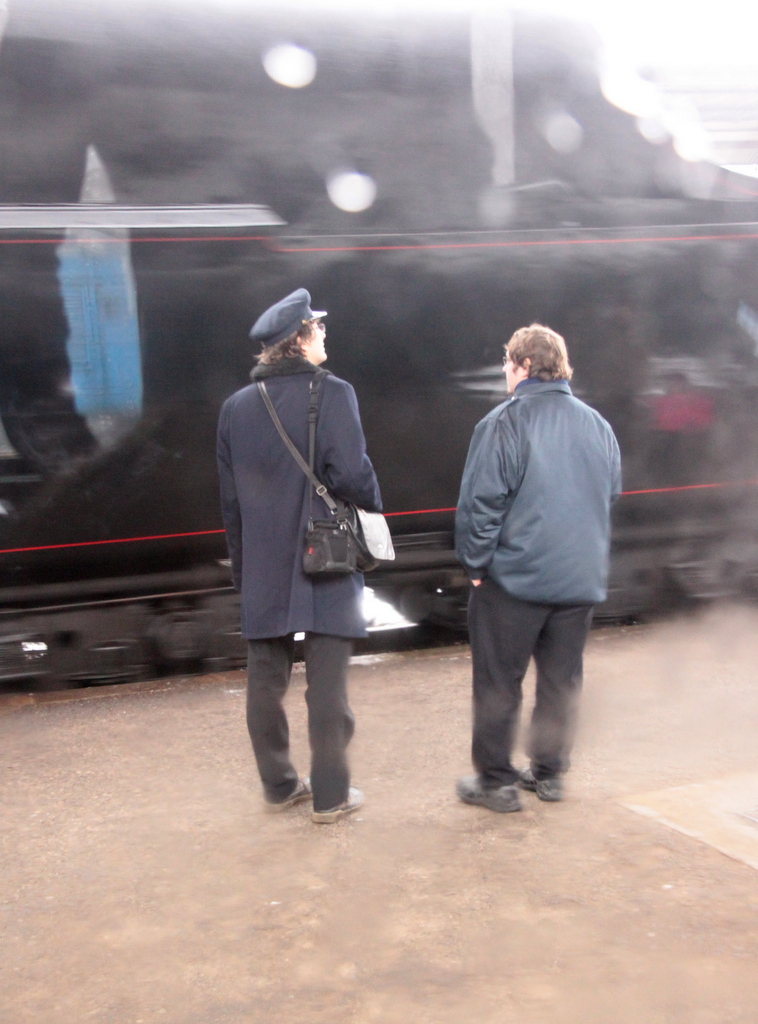 conductors watch a steam train in Beroun Czech Republic