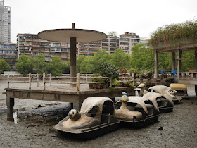 character-themed pedal boats sitting in a drained pond in Hengyang